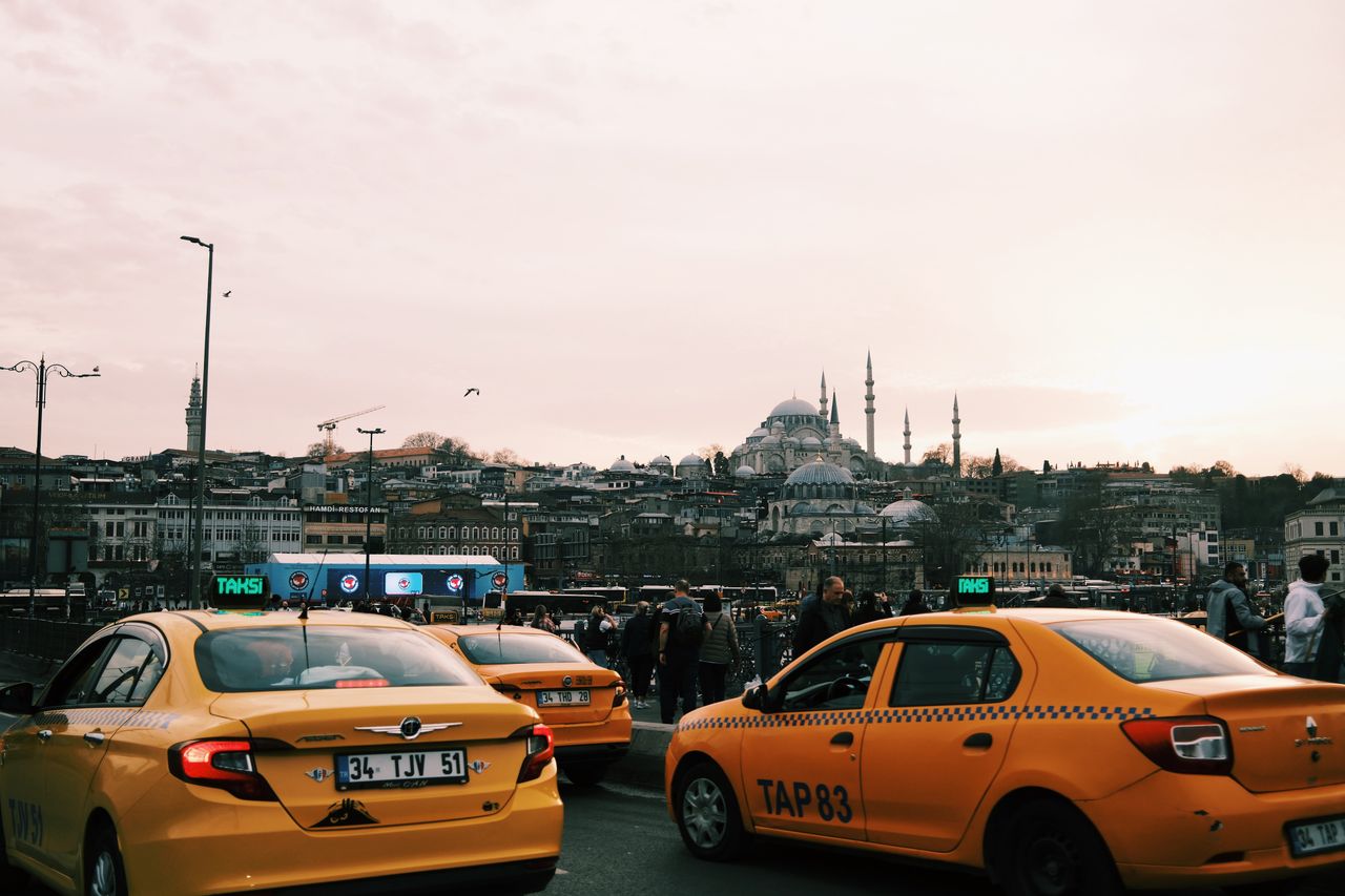about-img Yellow taxis navigate busy Istanbul streets with iconic mosques in the background.
