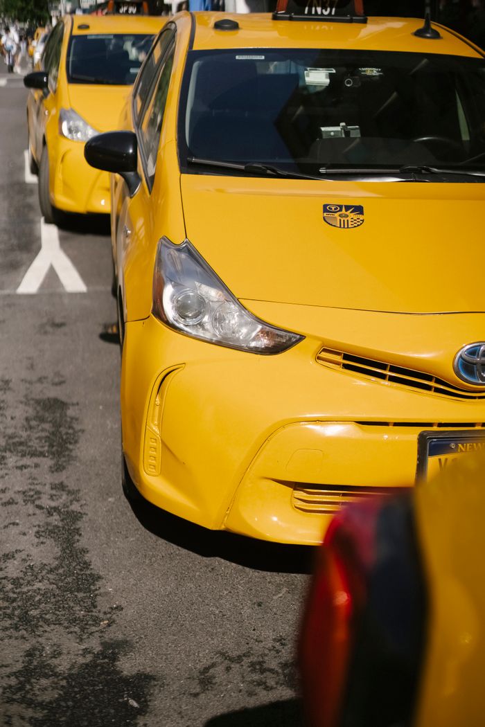 services-01 From above of bright yellow modern sports cab cars parked on urban roadway in sunlight